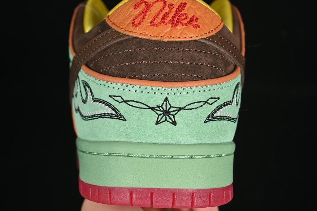 Rear view highlighting embroidered details, brown heel panels, and coral heel tabs.