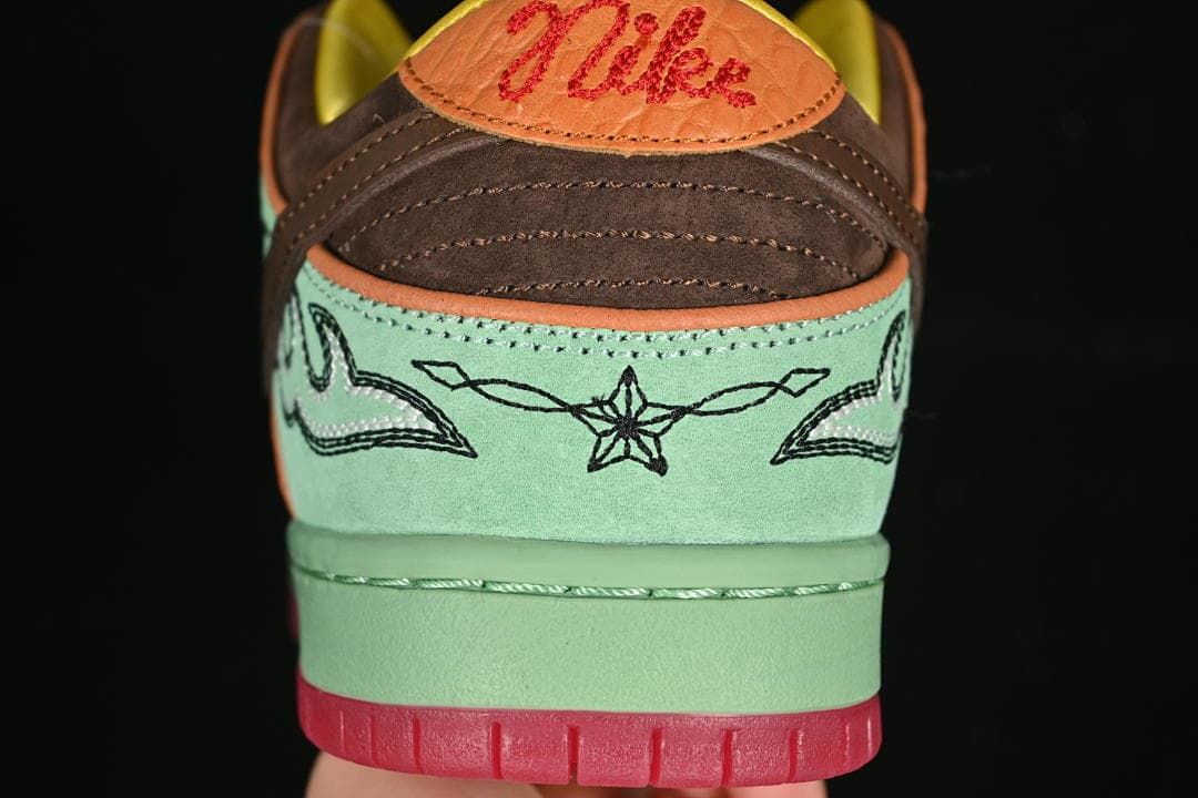 Rear view highlighting embroidered details, brown heel panels, and coral heel tabs.