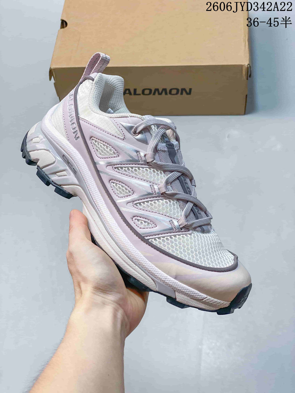 Angled side view of the sneaker with its layered upper and lugged outsole