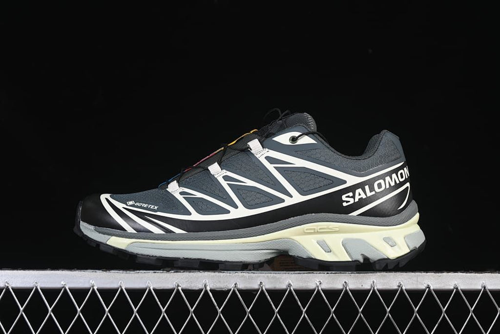 Side profile of a Salomon XT-6 GTX sneaker against a dark background.