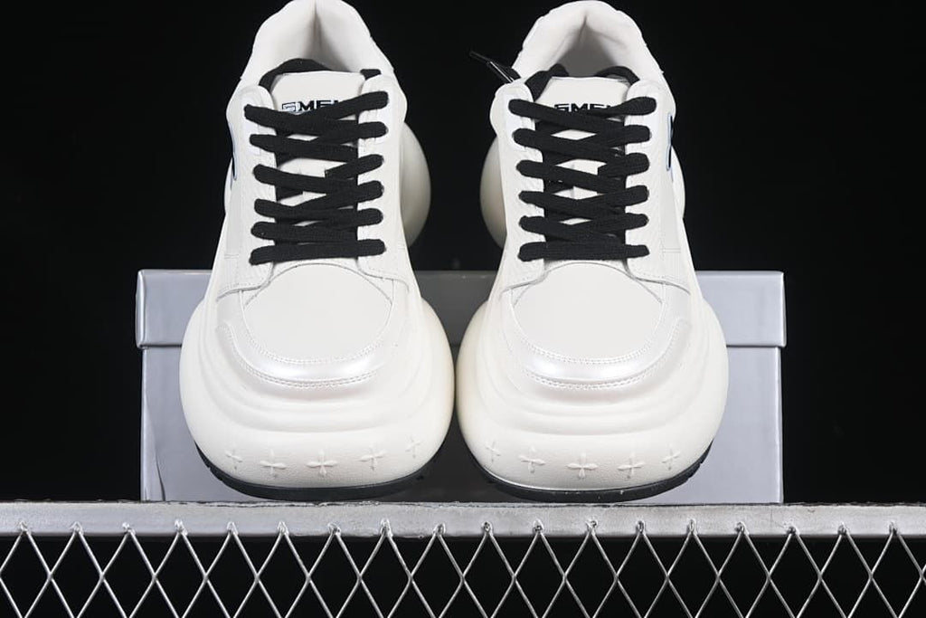 Front view of the pair with black laces and thick white soles