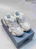 Pair of grey and silver New Balance 9060 sneakers on a shoebox