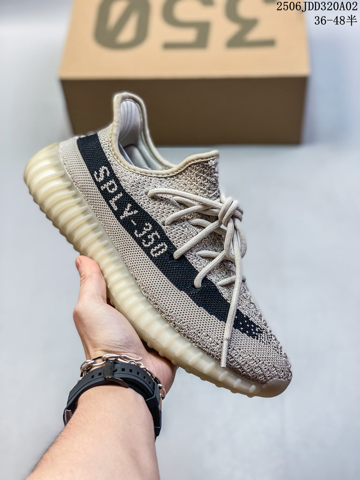 Light beige Adidas Yeezy-style sneaker with a dark side stripe