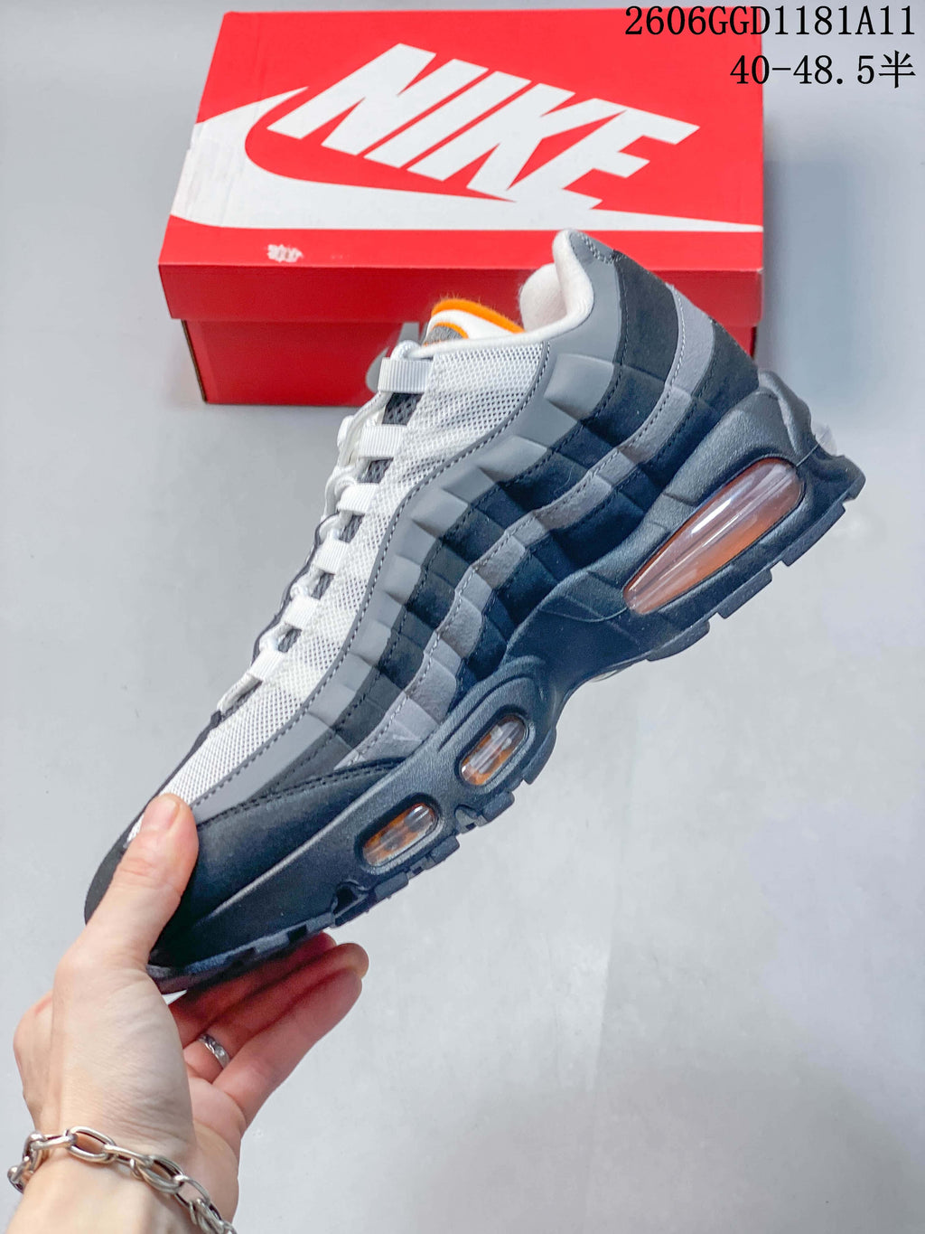 Side view of a Nike Air Max 95 OG sneaker showing layered panels and visible cushioning windows