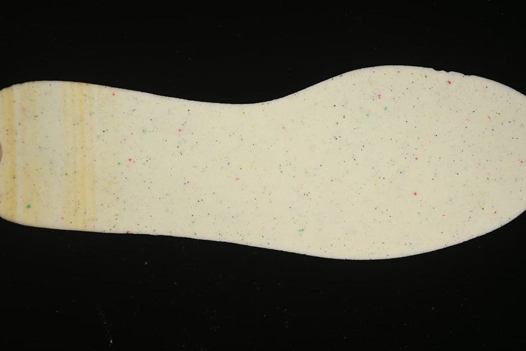 Light-colored sneaker insole with small multicolor speckles