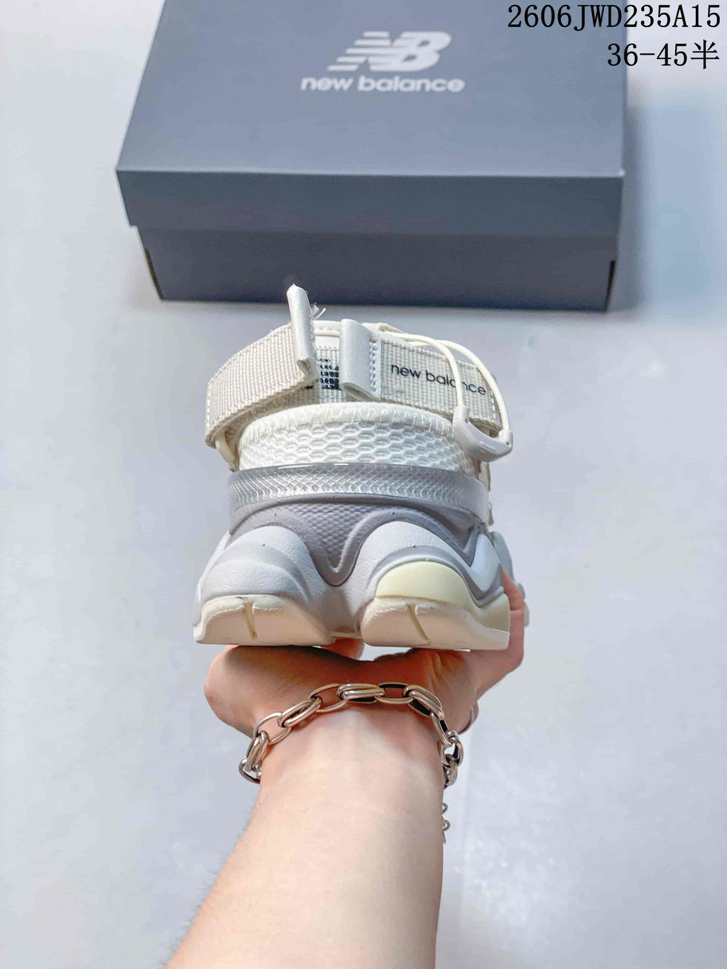 Rear view of a white and gray New Balance 9060 sneaker