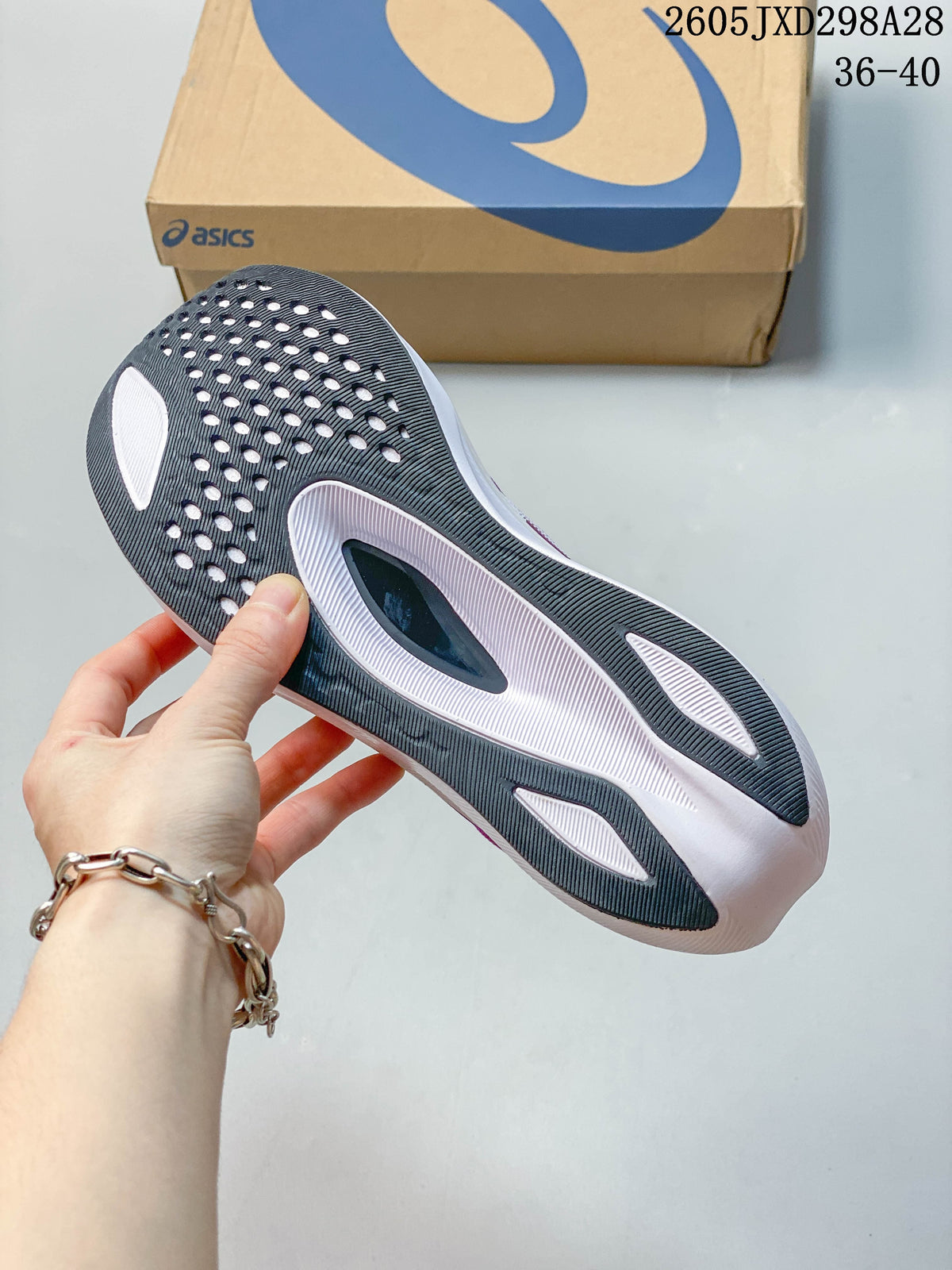 Underside of the ASICS running shoe showing a dark and white outsole