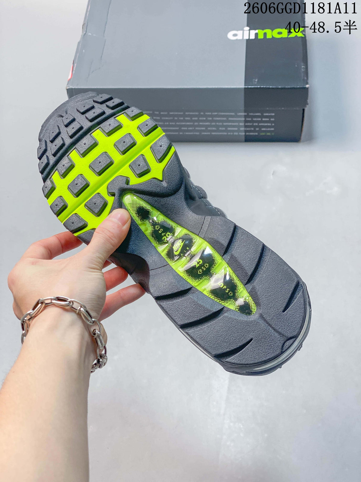 Underside of the sneaker showing a dark outsole with bright volt sections and a visible Air unit.