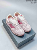 Pair of pale pink New Balance 471 sneakers with darker pink side logos, shown on a shoe box.