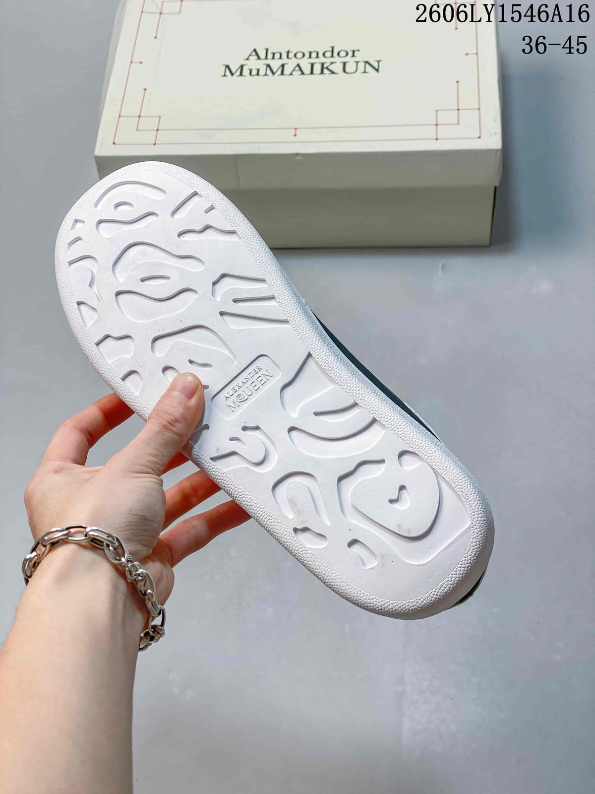 Underside of a sneaker showing a patterned white outsole