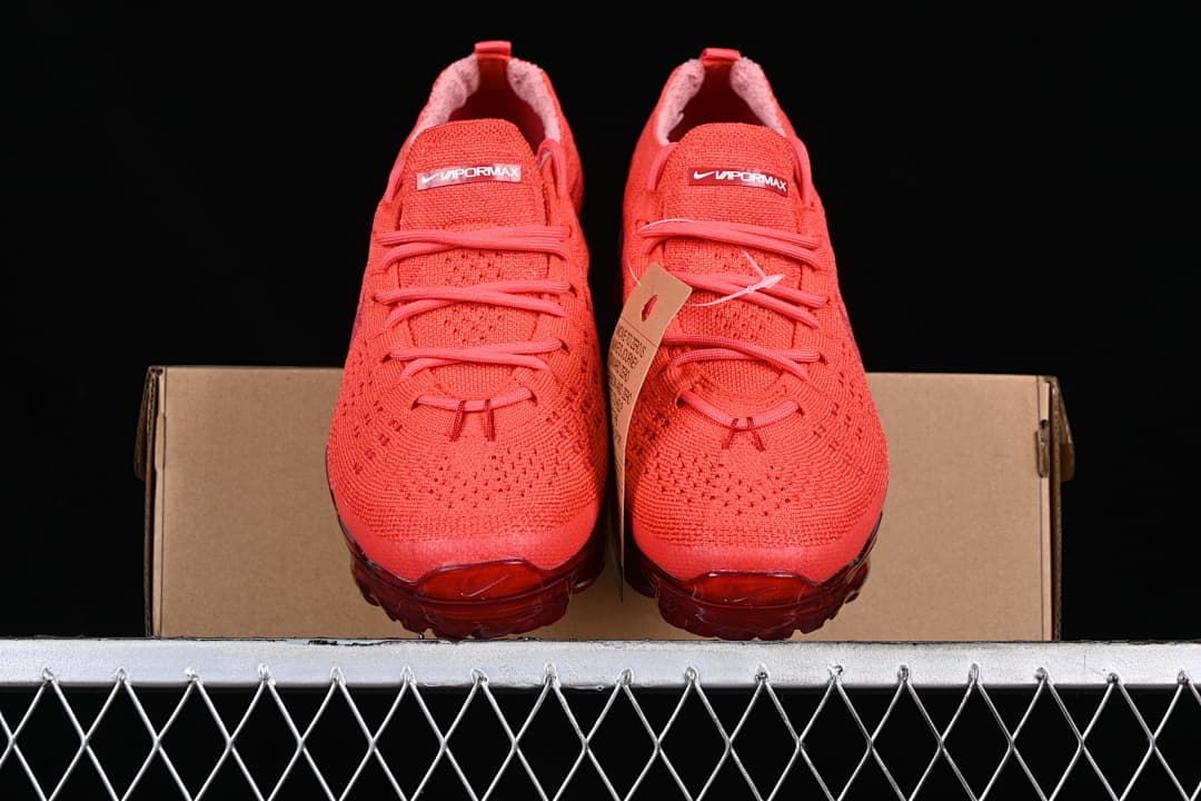 Front view of the pair of red knit sneakers