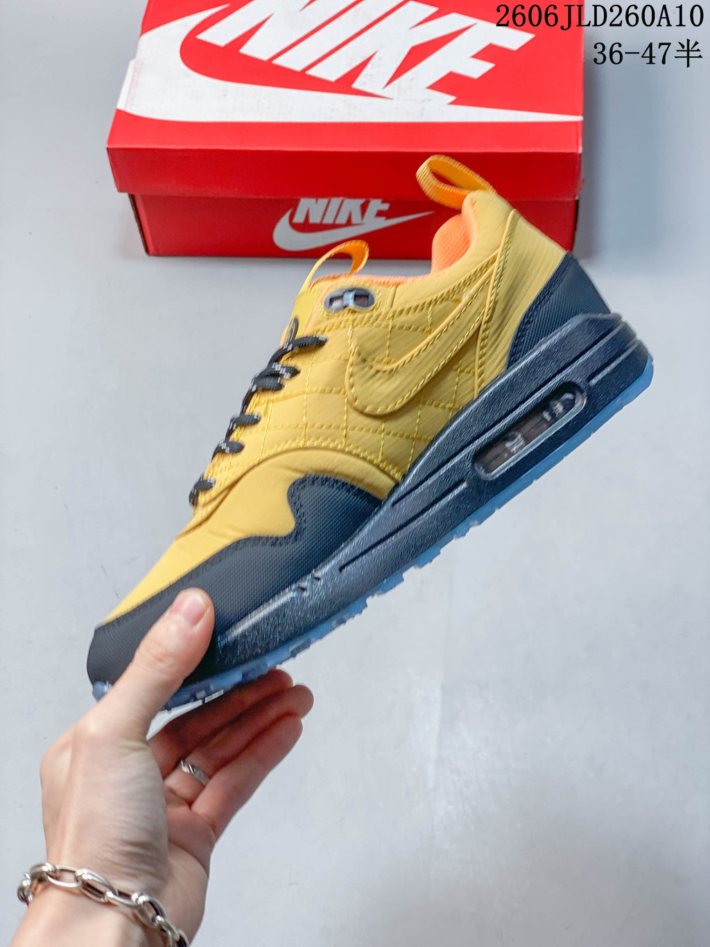 Side view highlighting the yellow upper, dark overlays, and midsole Air unit window
