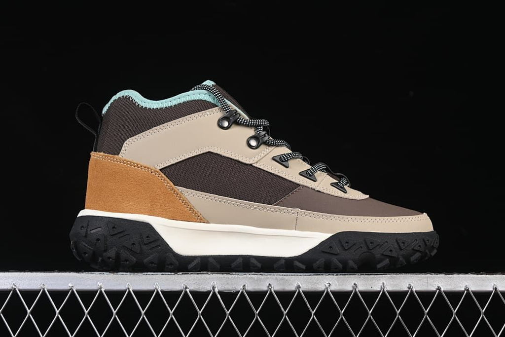 Side profile of a brown, gray, and tan mid boot