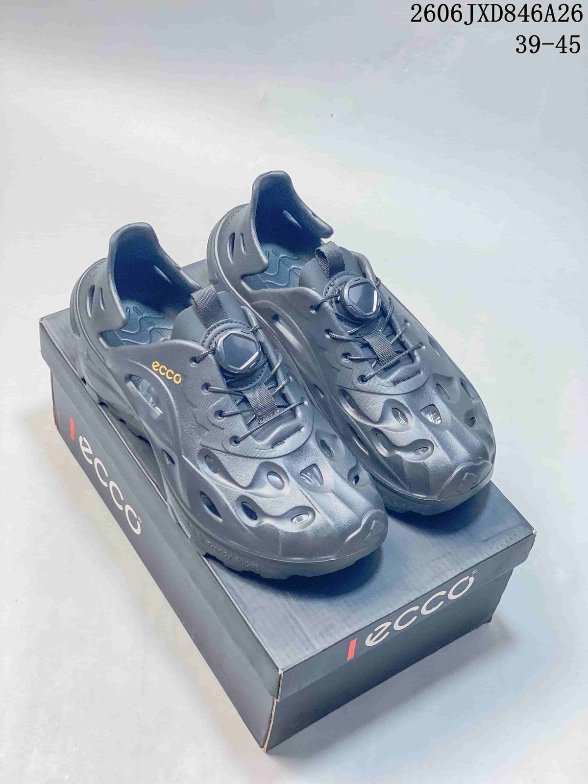Pair of dark gray perforated clog-style sandals with adjustable lacing on a branded box.