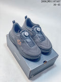 Pair of dark gray DESCENTE trail sneakers with dial closures and orange side details, shown on a shoe box.