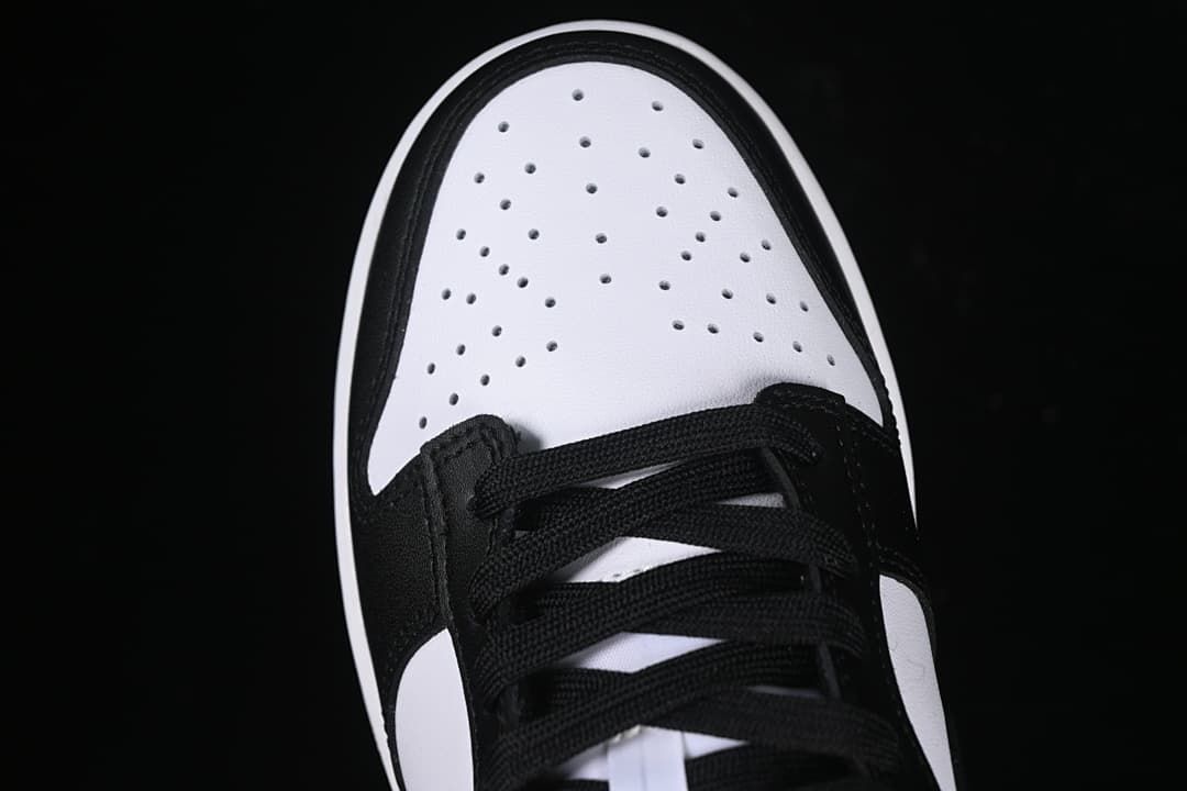 Top view of perforated white toe and black laces