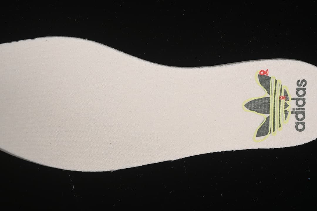Close-up of the shoe insole showing adidas branding.