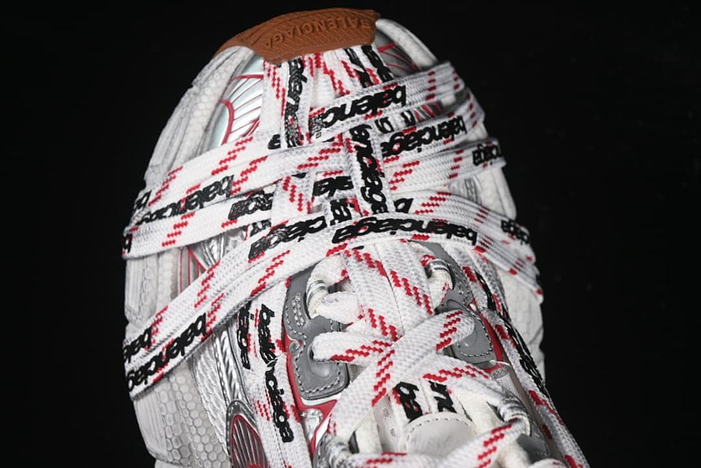 Top view of the sneakers showing the layered logo-patterned laces