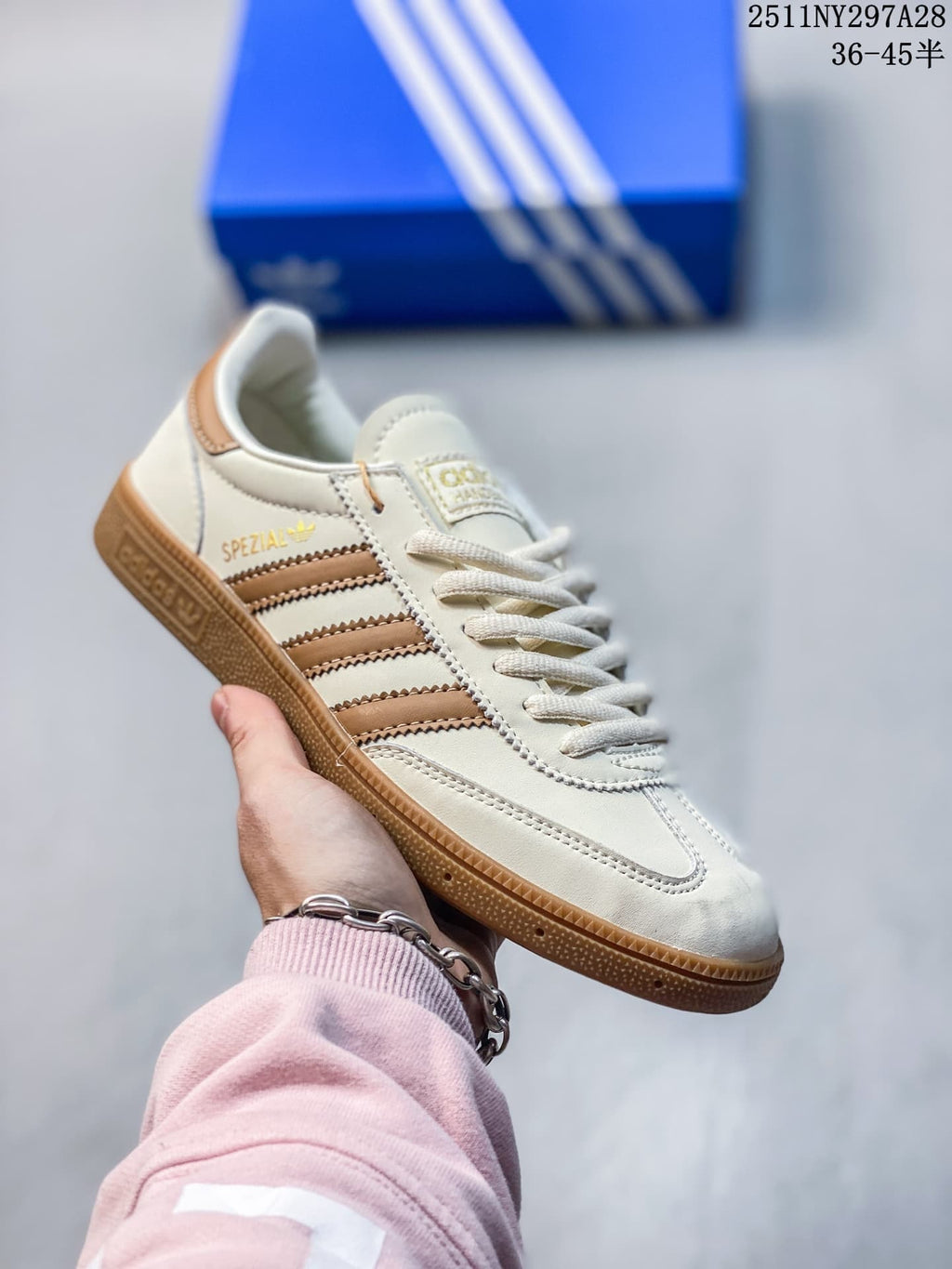 Off-white Adidas Spezial-style sneaker with tan stripes and gum outsole