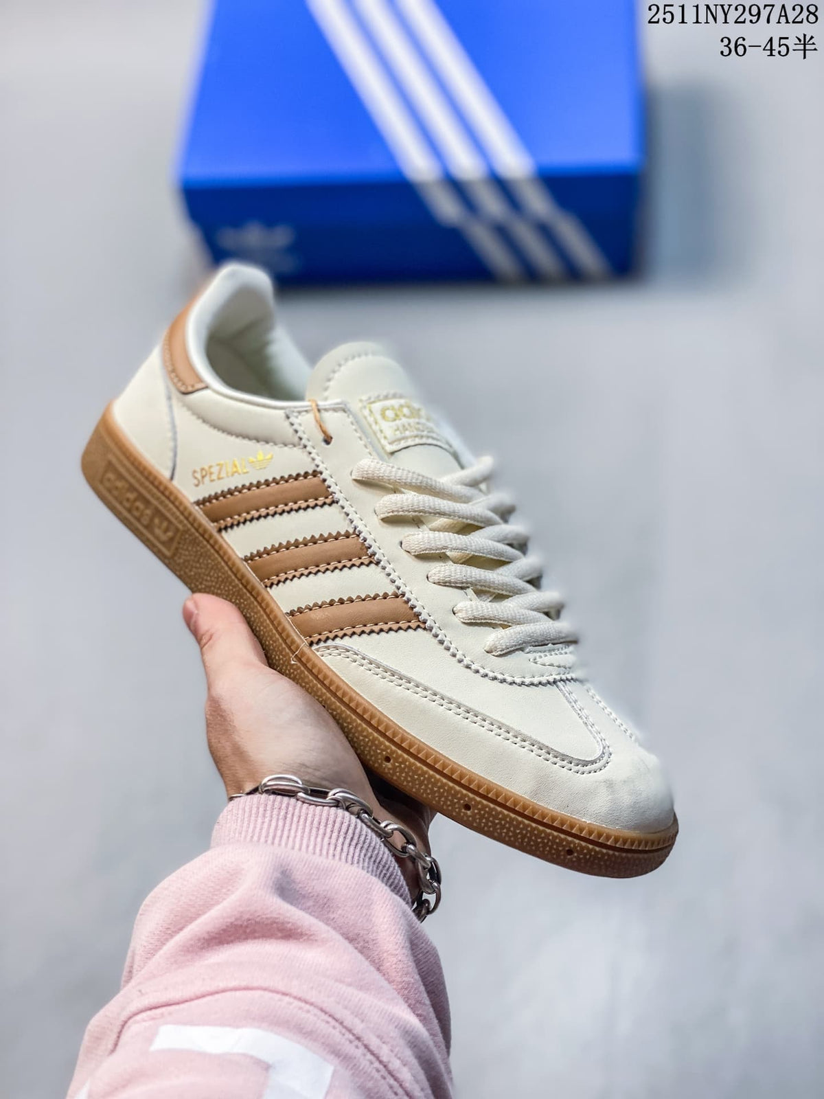 Off-white Adidas Spezial-style sneaker with tan stripes and gum outsole