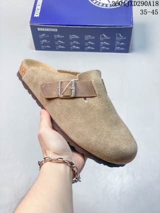 Tan suede closed-toe clog with a metal buckle and contrasting outsole edge.