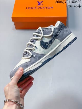 Side view of the white and gray sneaker showing the patterned side panel, contrast Swoosh, white midsole, and dark outsole.