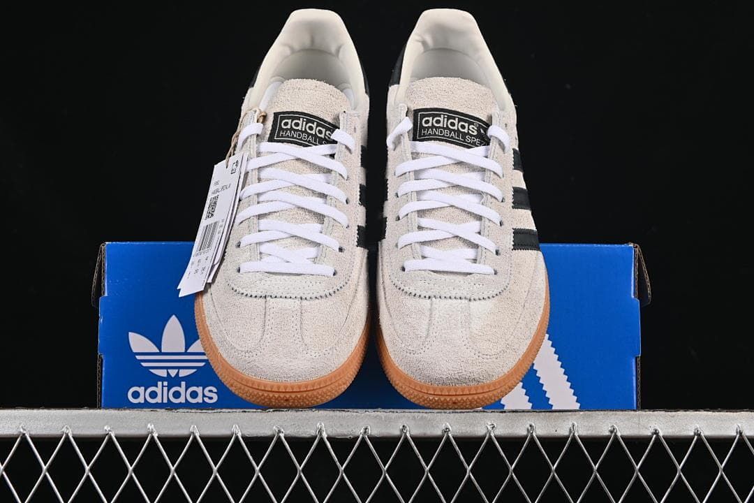 Front view of the pair displayed on an adidas shoebox