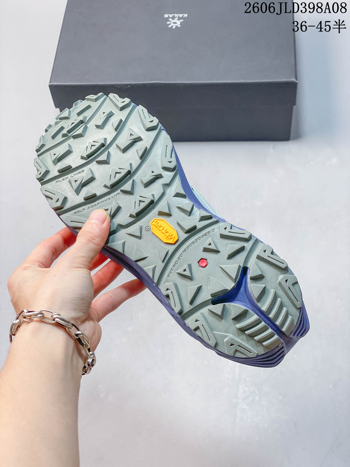 Close-up of the trail shoe outsole showing a lug pattern and Vibram mark
