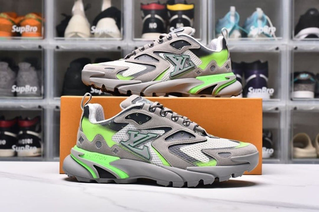 Pair of gray and lime green sneakers shown from the side