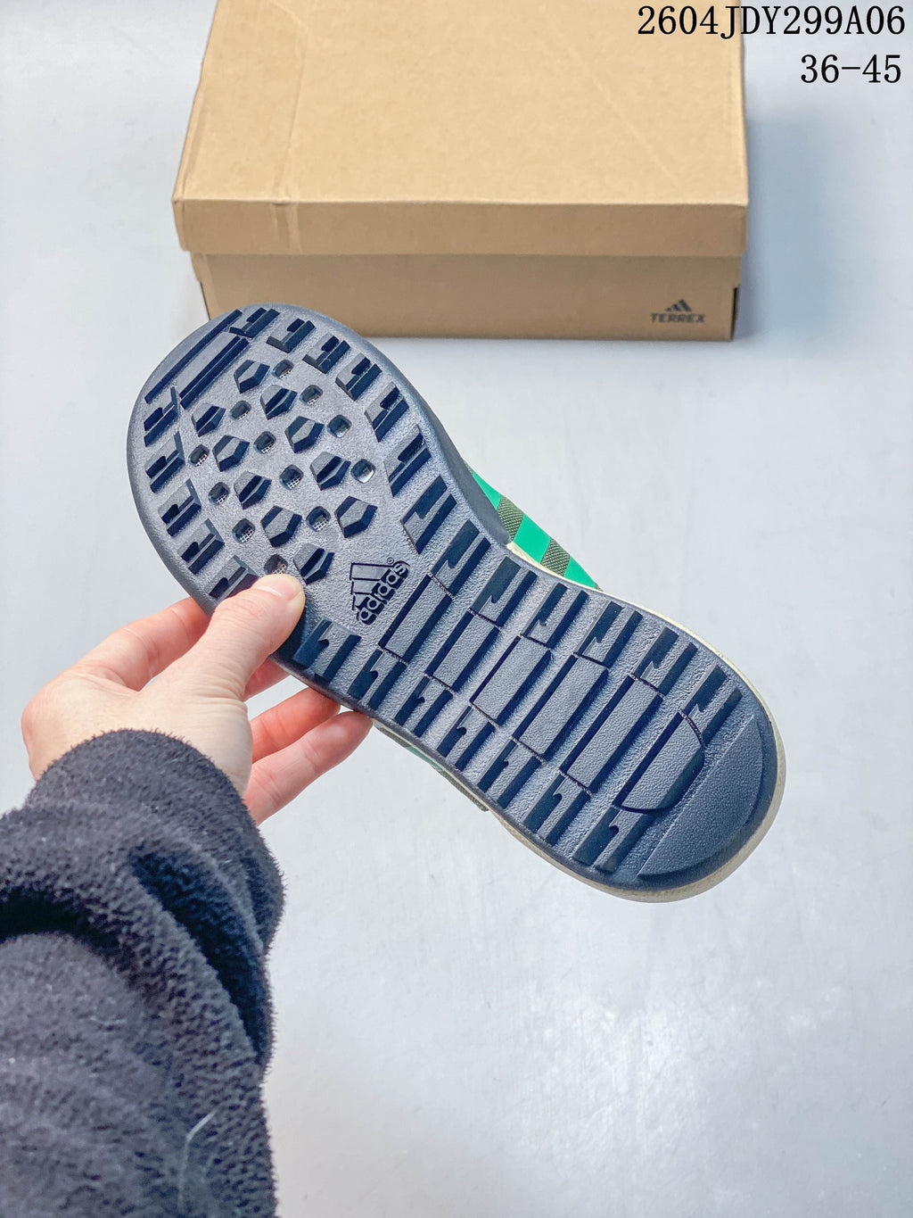 Close-up of the dark patterned outsole on an Adidas outdoor shoe