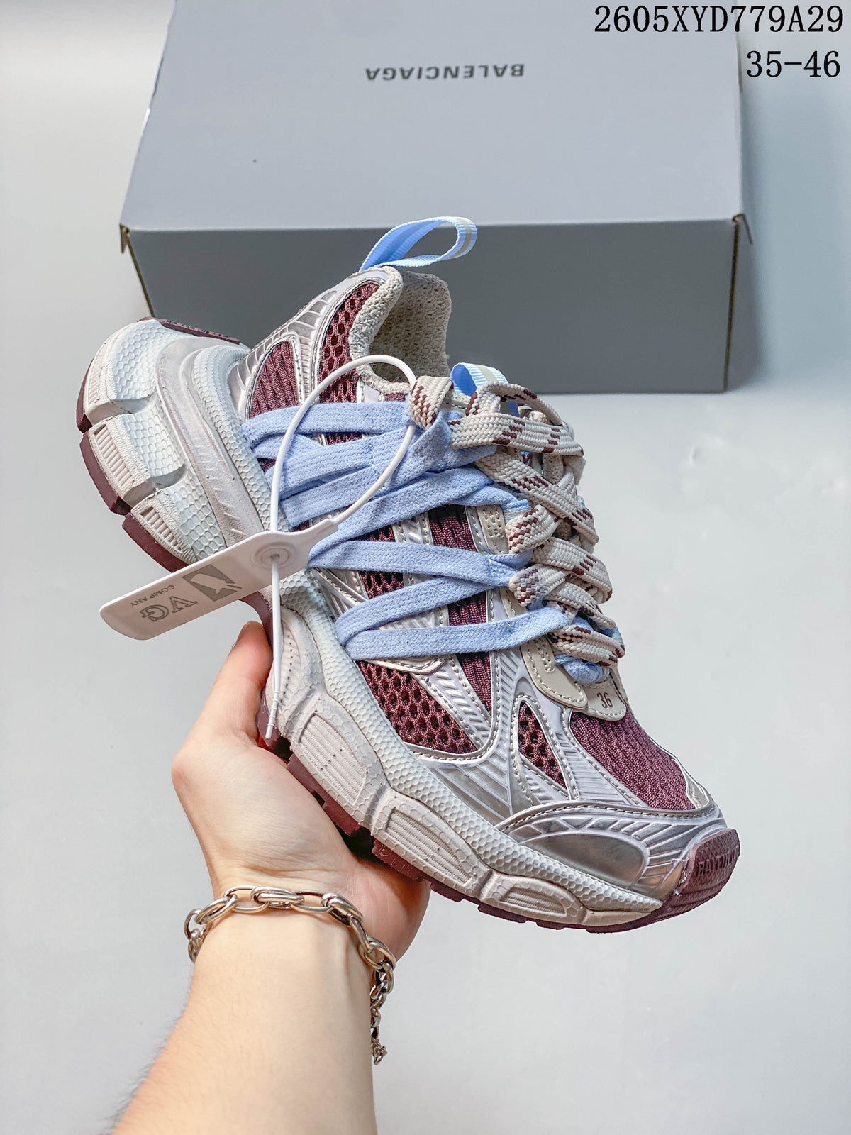 Angled side view of a Balenciaga Phantom sneaker with pale blue laces, silver detailing and a chunky sole.