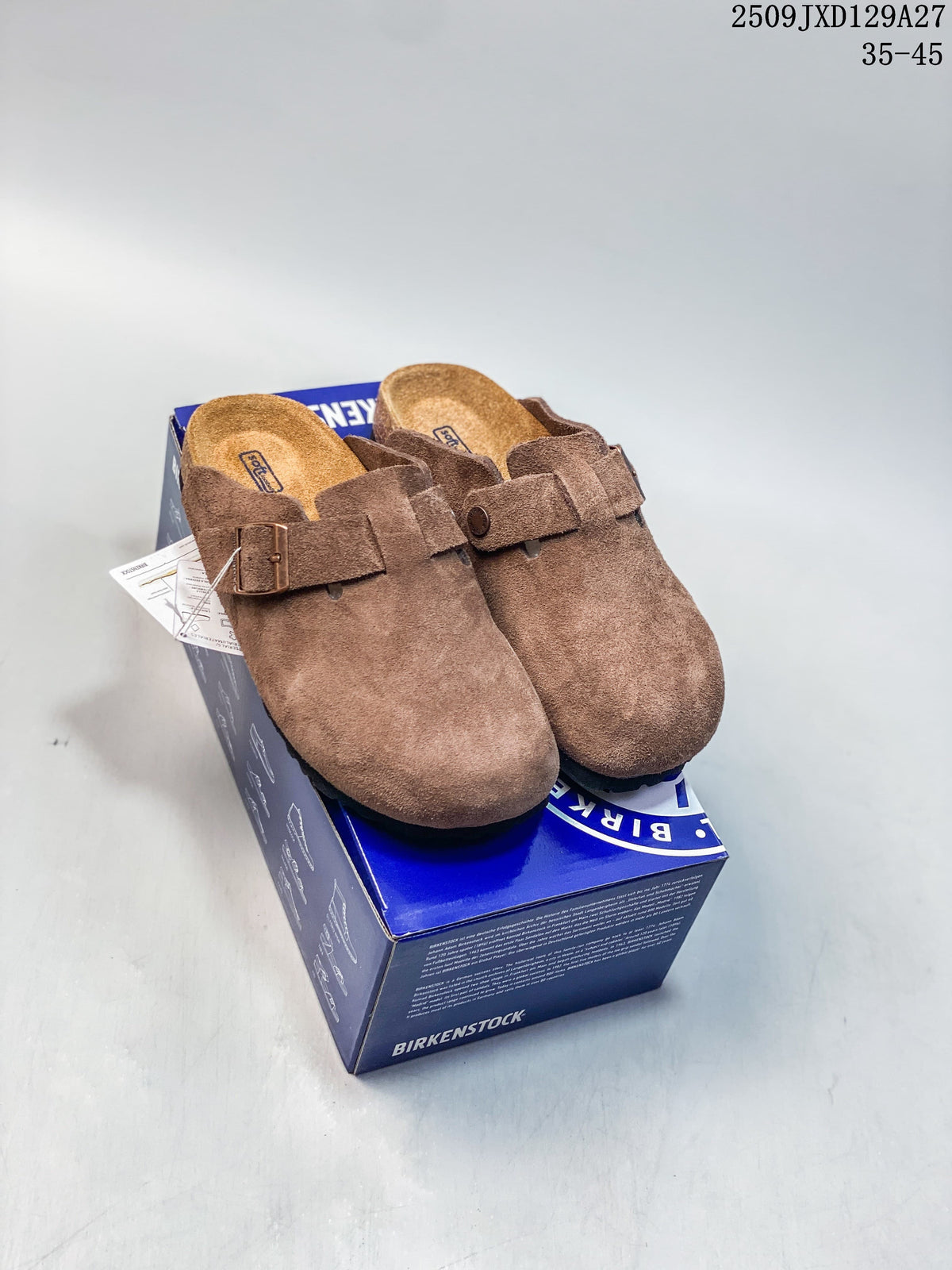 Pair of brown closed-toe buckle clogs displayed on a shoe box