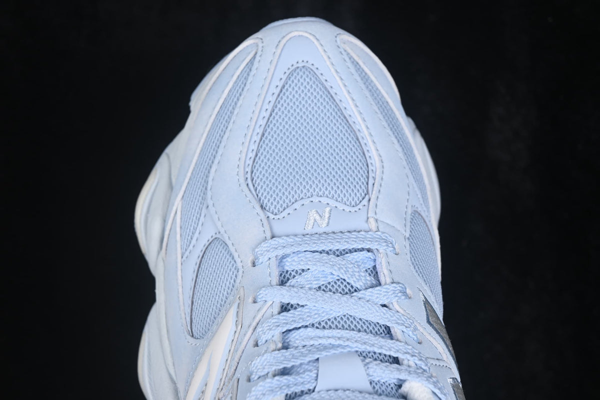 Close-up top view highlighting the mesh toe box, stitched overlays, and light blue laces.