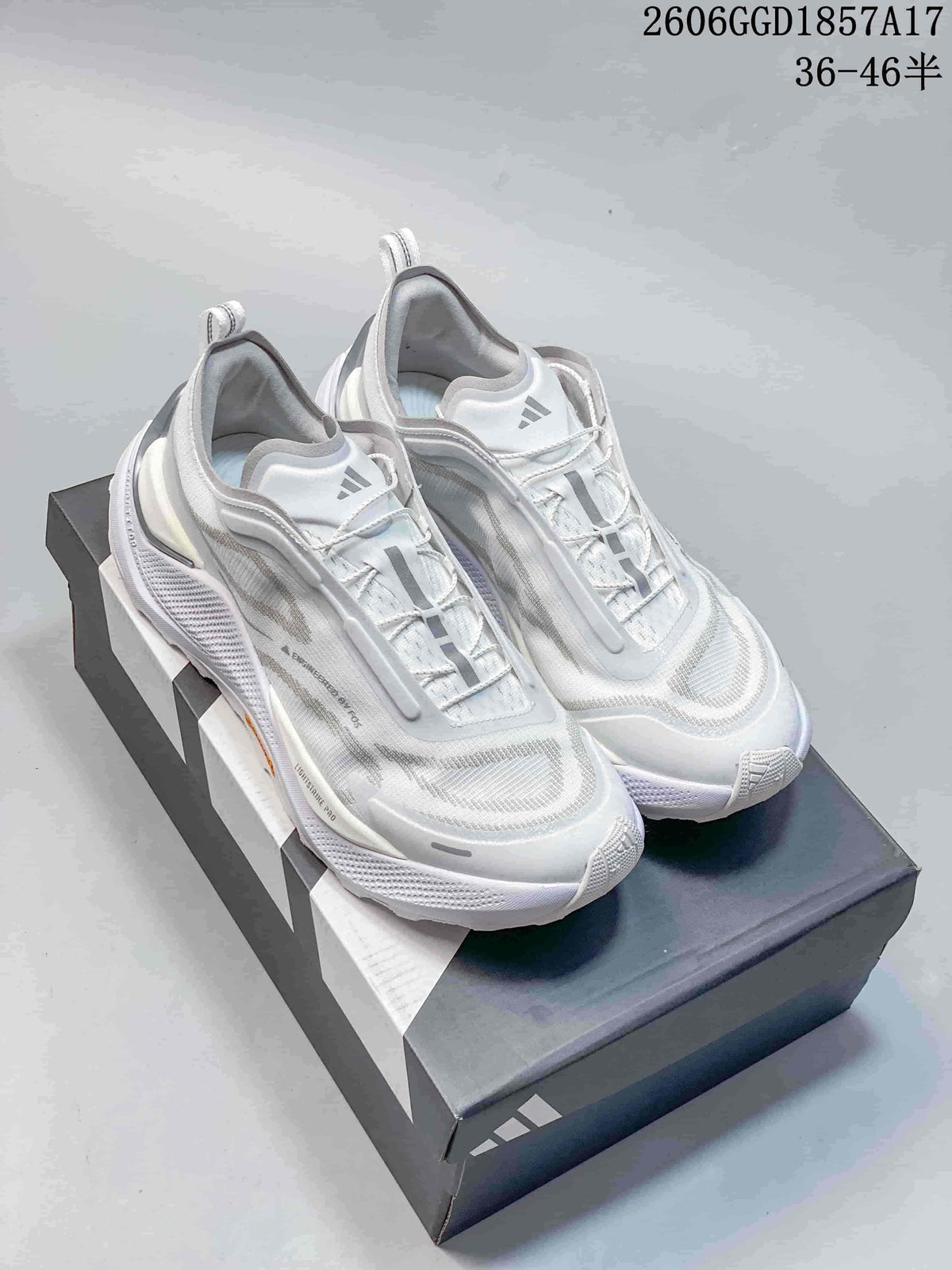 Pair of white adidas HOLO PEAK trail shoes on a shoebox.