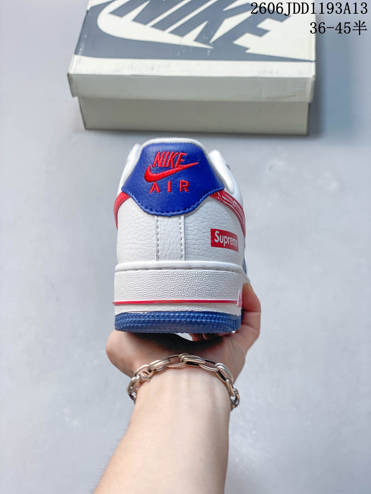 Rear view of the white, blue, and red sneaker, showing heel details