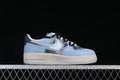 Side view of a pale blue low-top sneaker with a silver-toned Swoosh, off-white sole and black laces