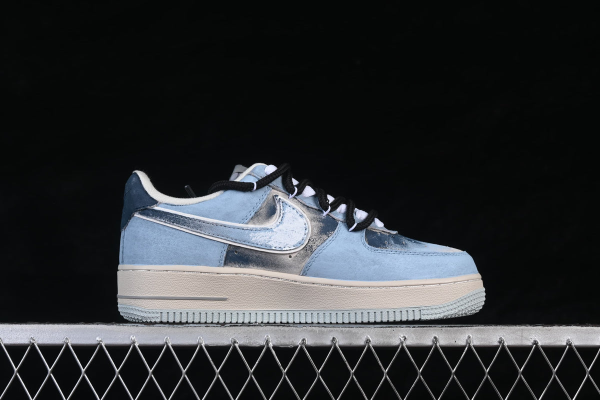 Side view of a pale blue low-top sneaker with a silver-toned Swoosh, off-white sole and black laces