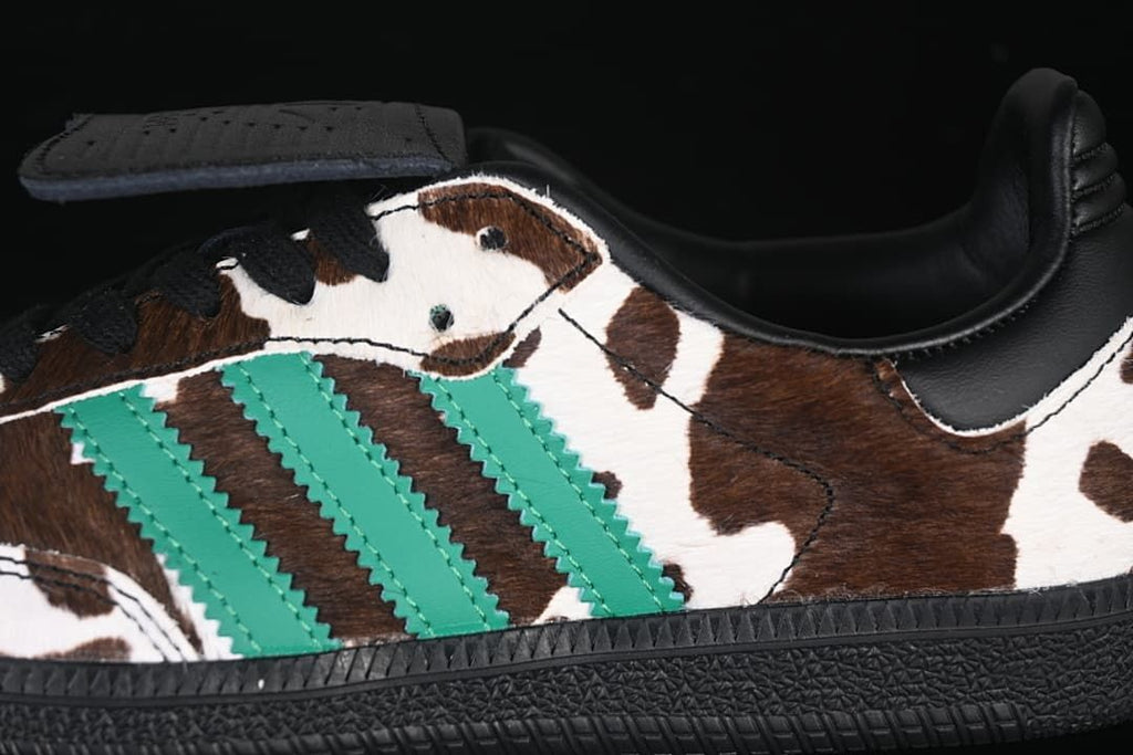 Close-up of green side stripes against the brown-and-white cow-print upper