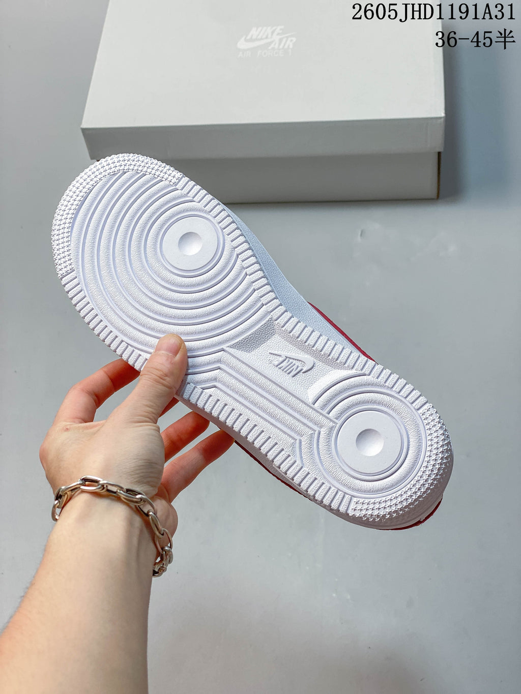 Close-up of the white textured outsole on a low-top Air Force 1 sneaker