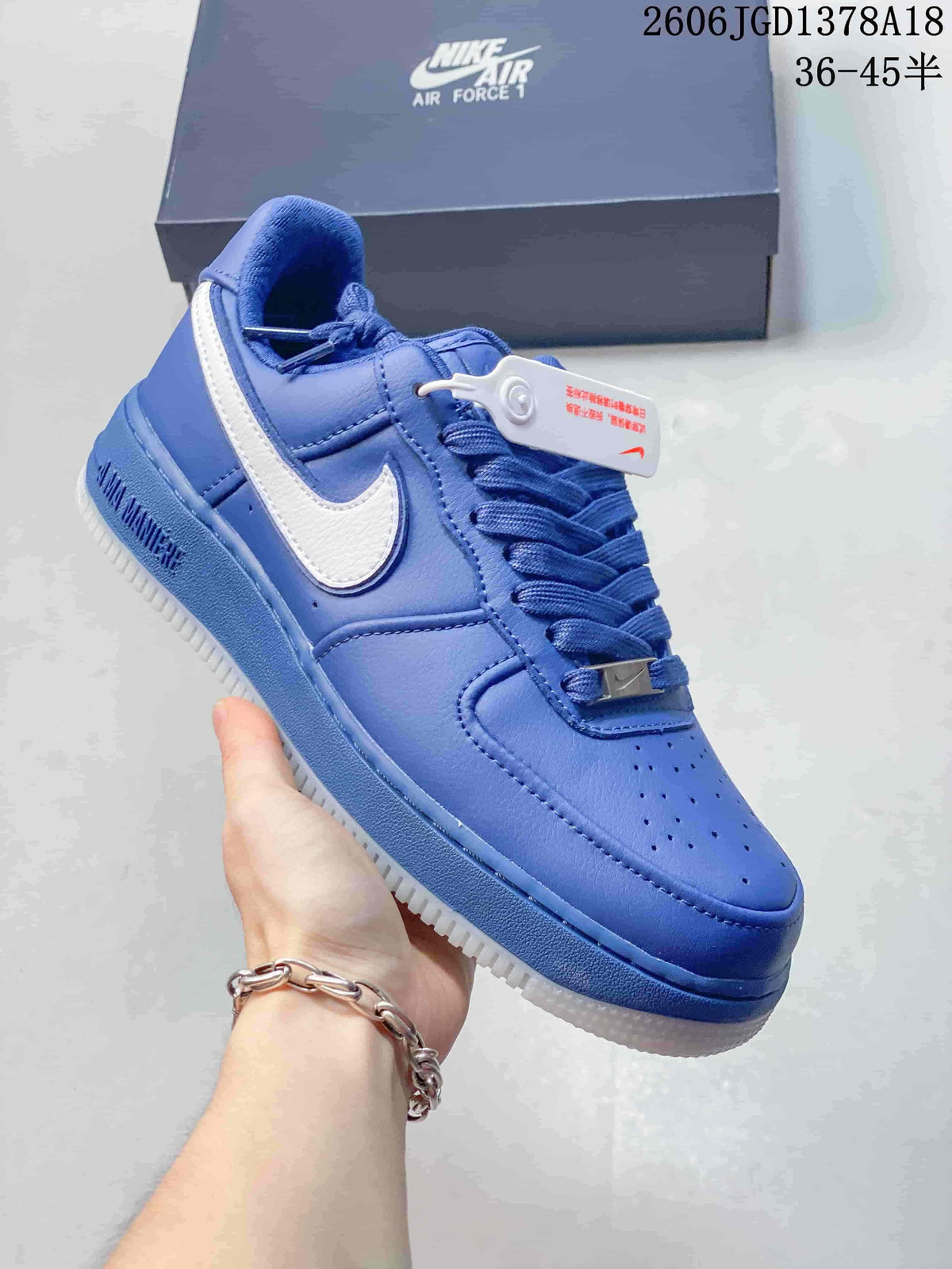 Angled side view of a blue low-top sneaker with white Swoosh detailing