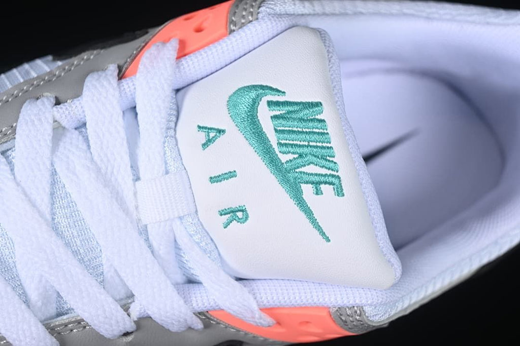 Close-up of the tongue with teal Nike Air embroidery and white laces.