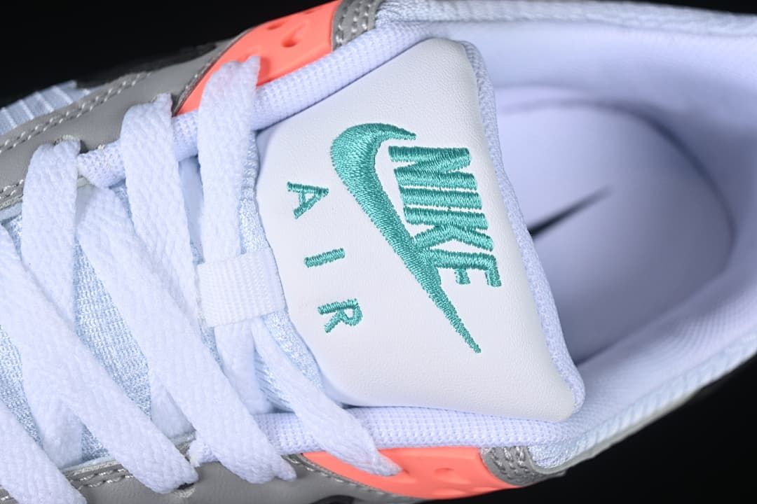 Close-up of the tongue with teal Nike Air embroidery and white laces.