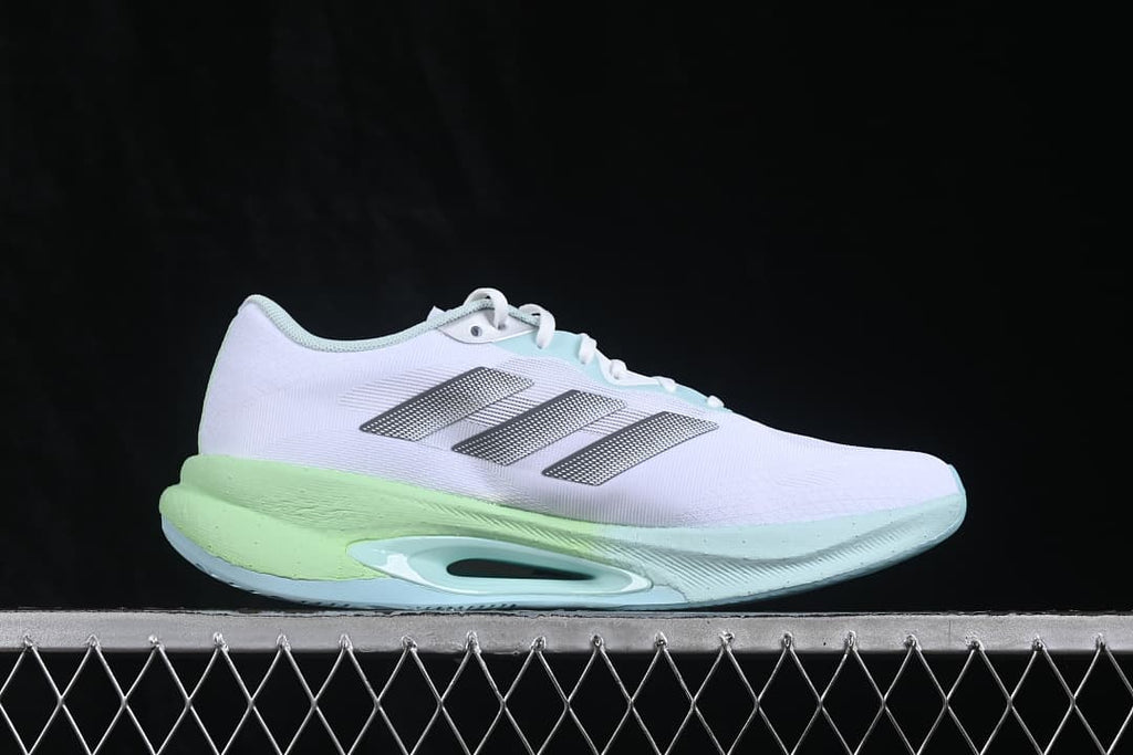 Side profile of the white sneaker with silver stripes and lime midsole