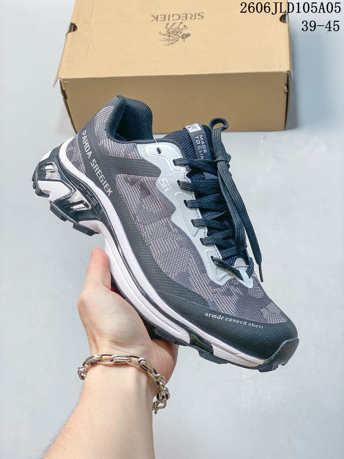 Angled side view of the gray SREGIEK sneaker with a lugged outsole.
