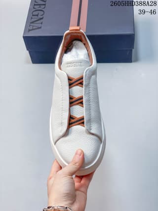 Top view showing the white upper, tan accents, and two-tone laces.