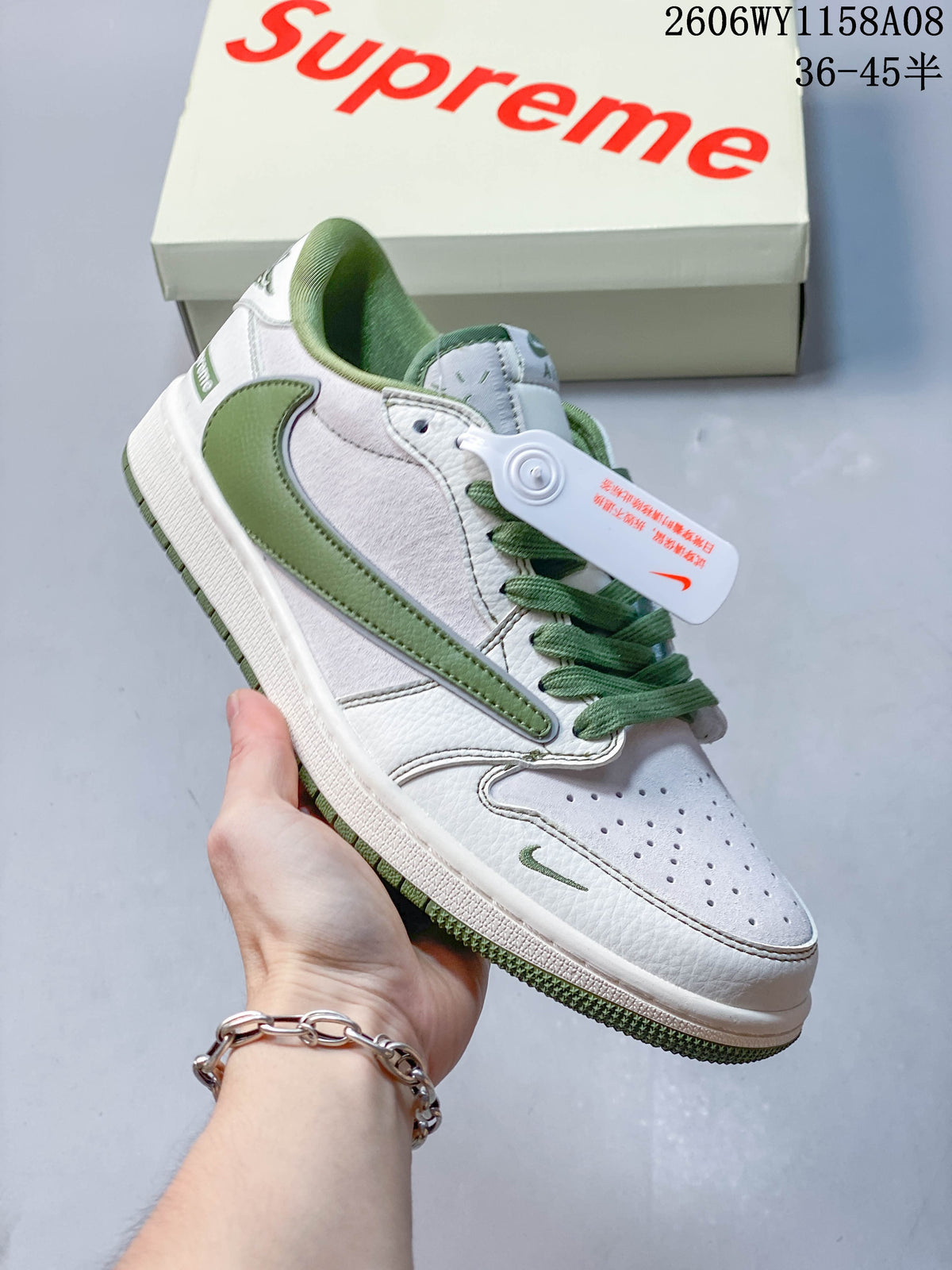 Angled close-up of the off-white and green sneaker upper