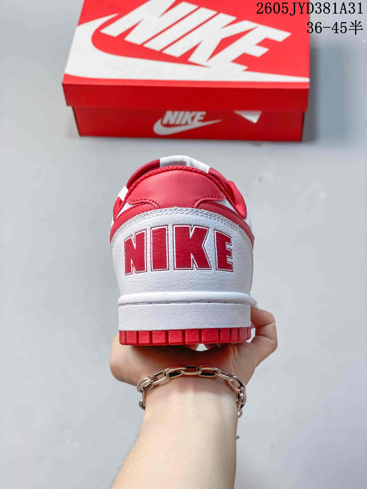 Rear view of a white sneaker with red heel details and outsole