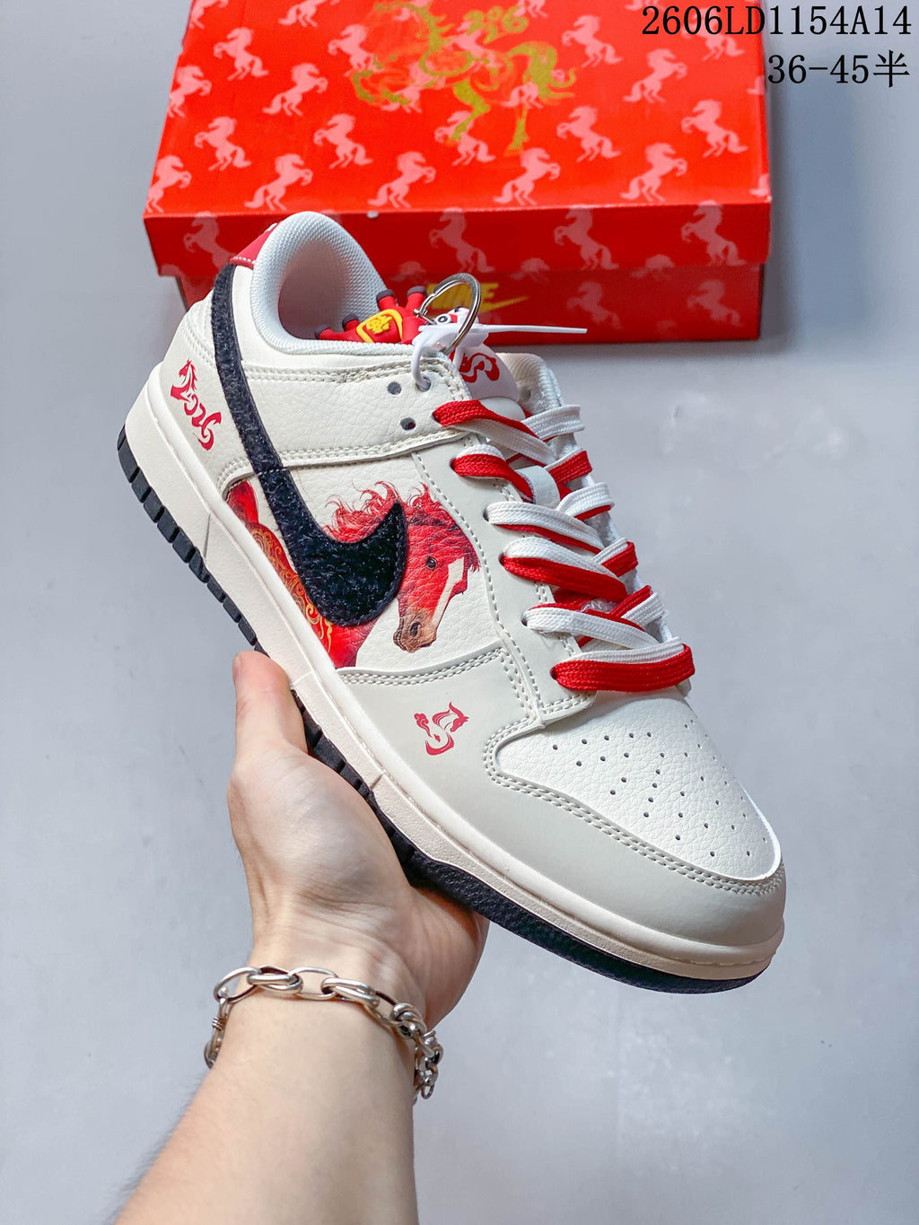 Cream Nike SB Dunk Low with red and navy accents, horse artwork, and contrasting laces