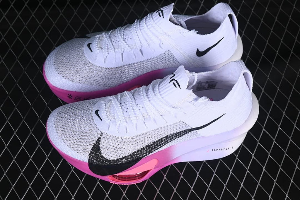 Pair of white, black, and pink Nike Alphafly 3 running shoes