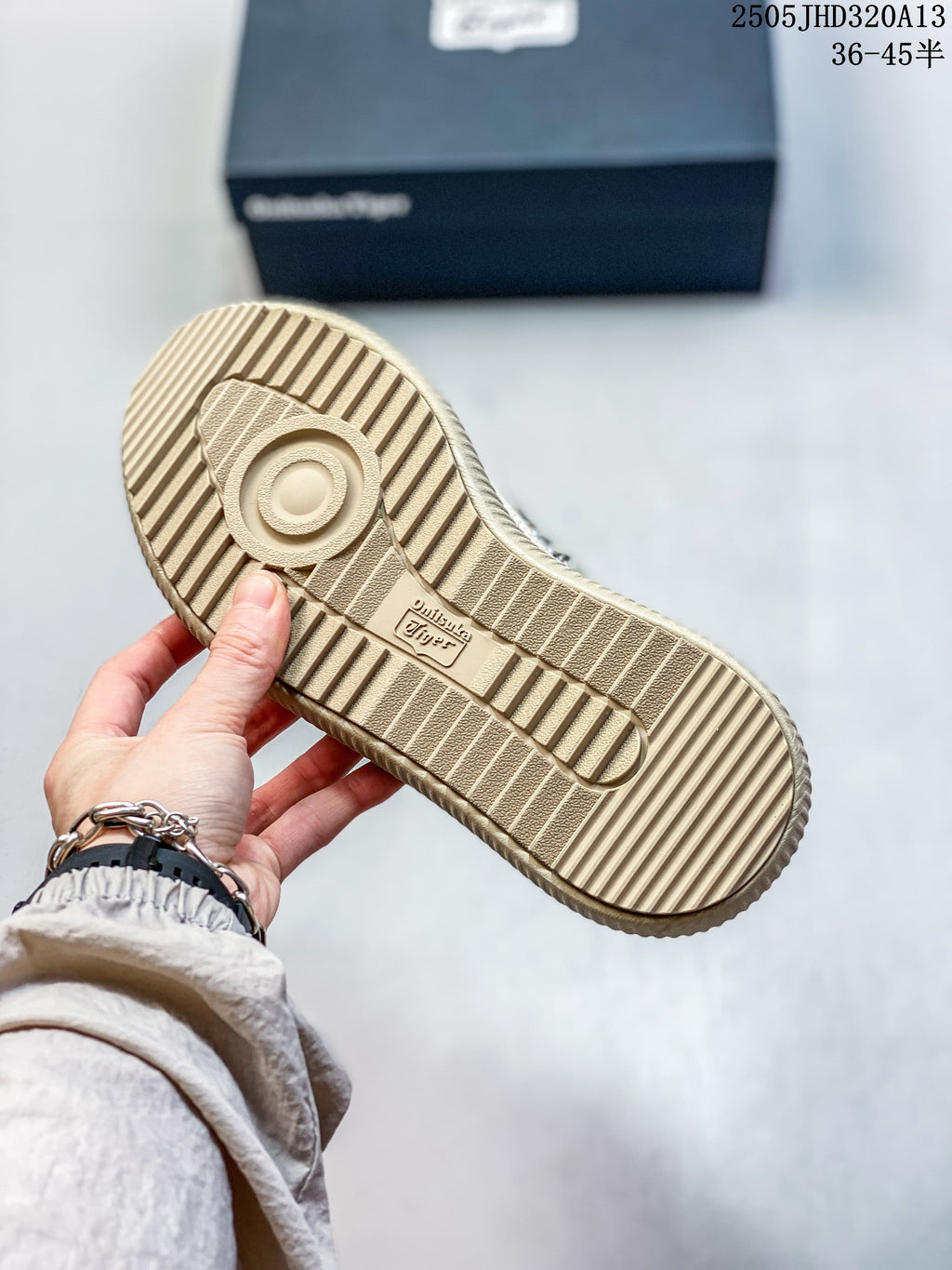 Underside of a beige Onitsuka Tiger sneaker showing a ribbed outsole